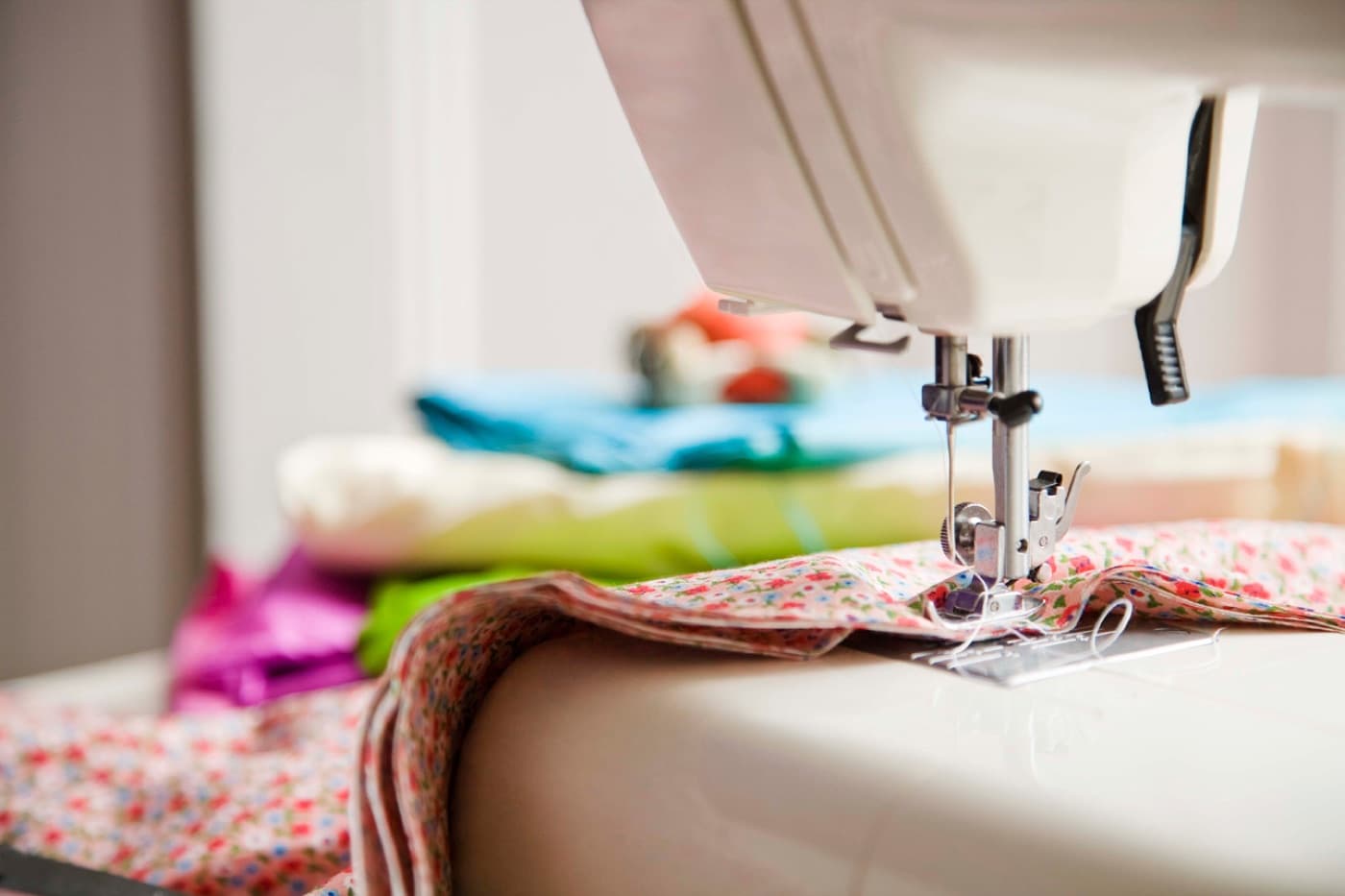 Fabric being fed through a sewing machine in the Mindzye studio