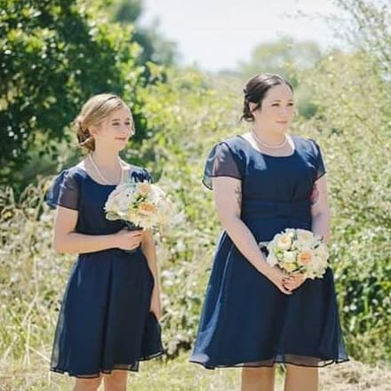 Two bridesmaids in matching navy dresses made in the studio